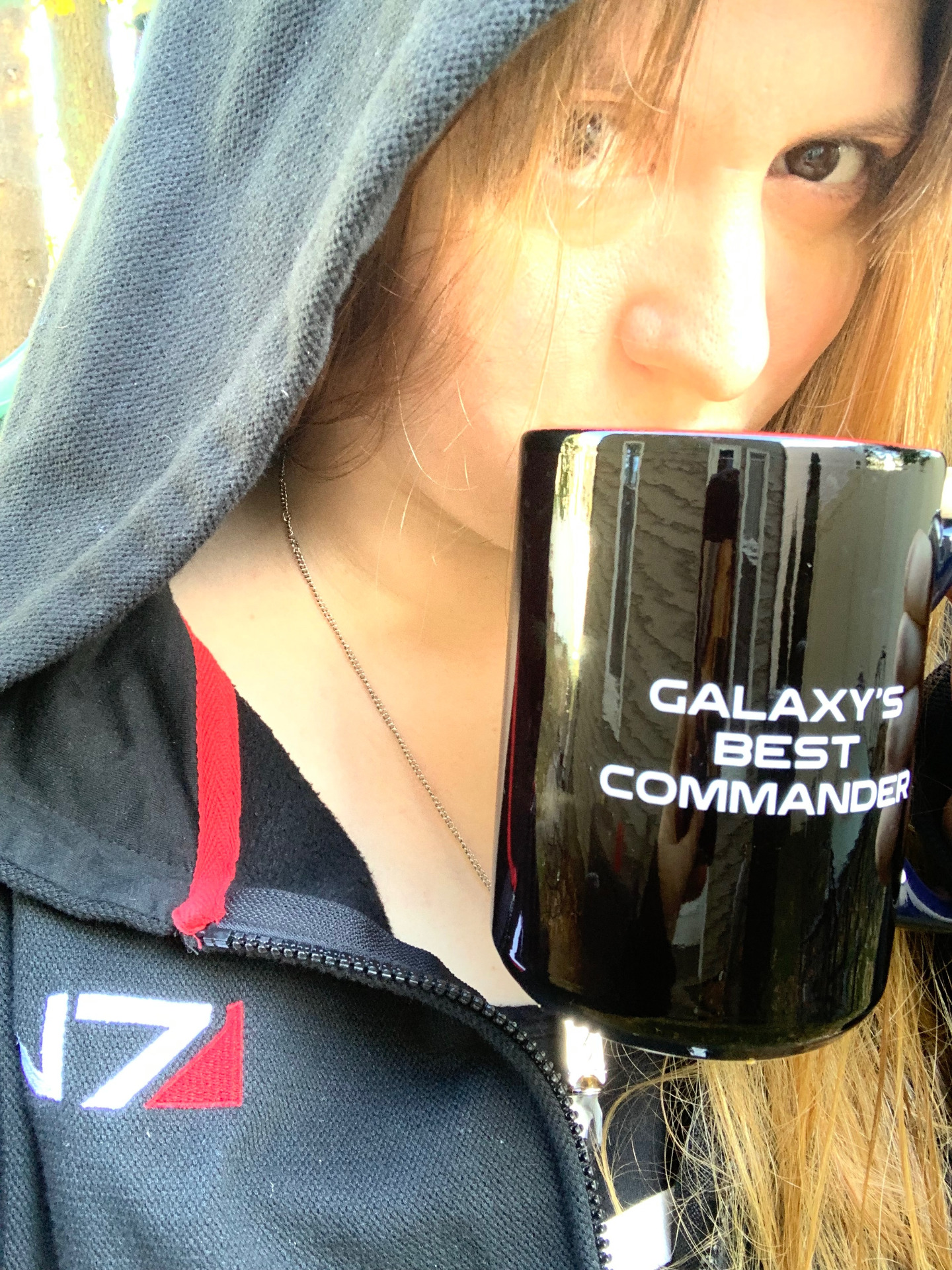 Bunny (she/her) drinking from a Galaxy's Best Commander mug